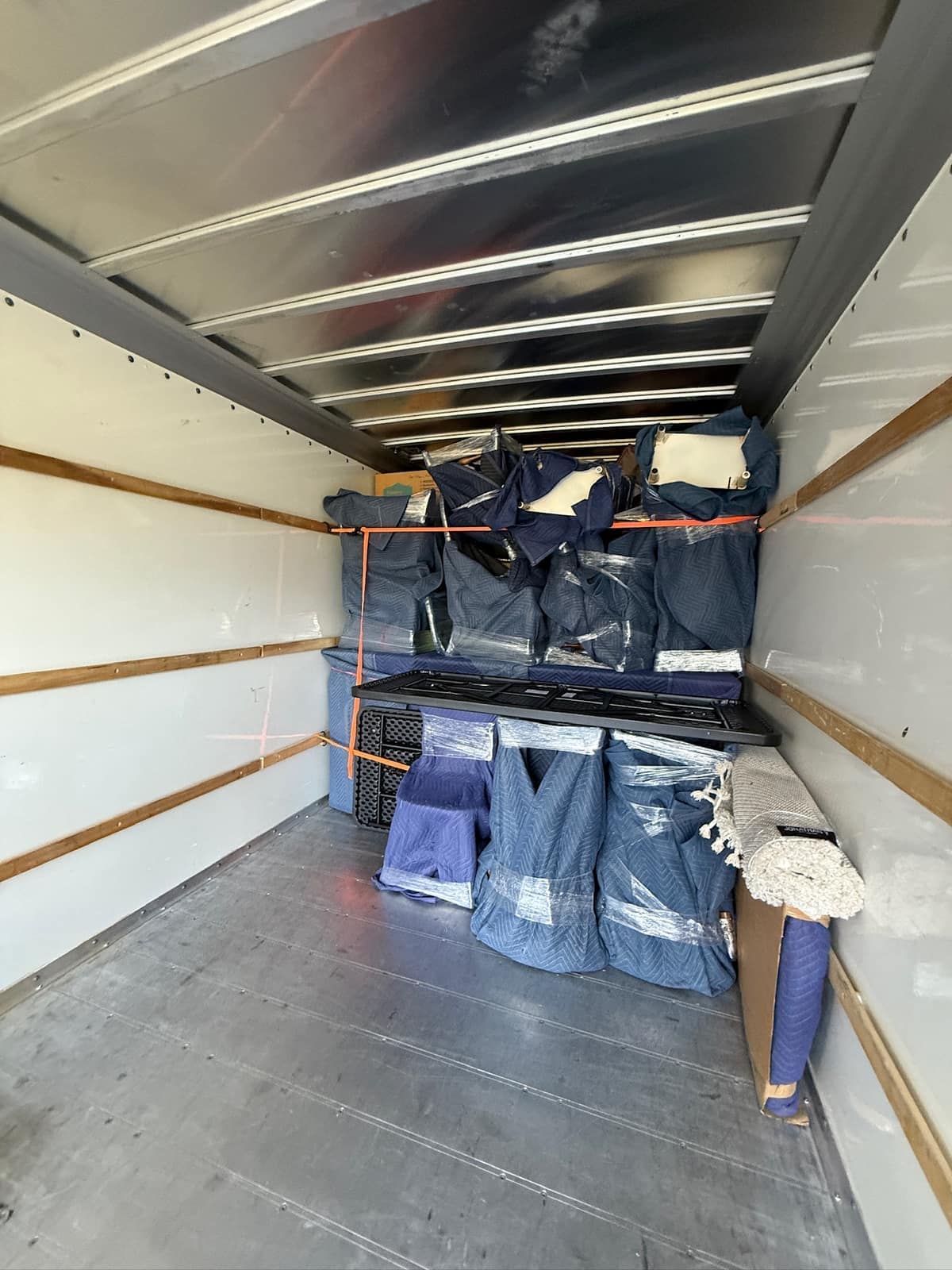 Movers loading boxes into a container